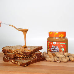 Joe's Peanut Butter spread on multigrain bread with peanuts