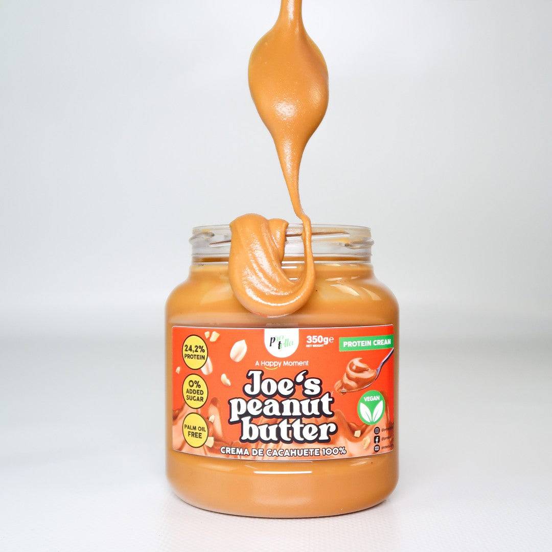 Spoonful of Joe's Peanut Butter dripping back into jar