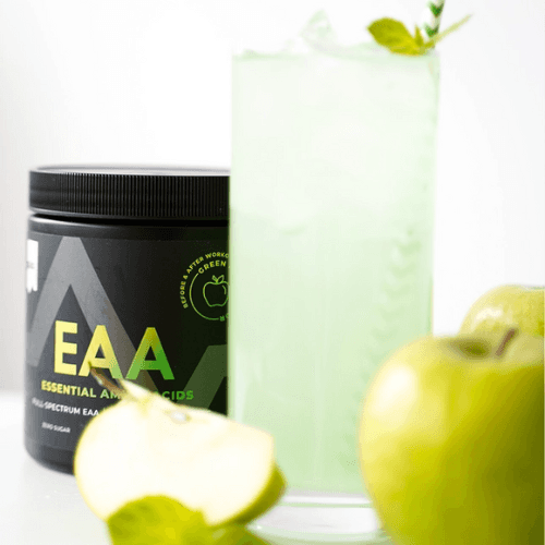 a green apple next to a jar of eaa