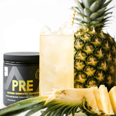 a pineapple next to a pineapple and a jar of pre workout complex